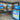 TV screens and samples of trusses and doors in the Turkstra Lumber showroom with a sign that says 'Build-It Better'