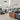 Modern hardware store interior with a checkout counter and various products on shelves in the distance