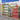 Rendering of window display with pet supplies including cans, bowls, and boxes in a store setting.