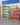 Rendering of pet products window display including food containers and bowls in a store setting.
